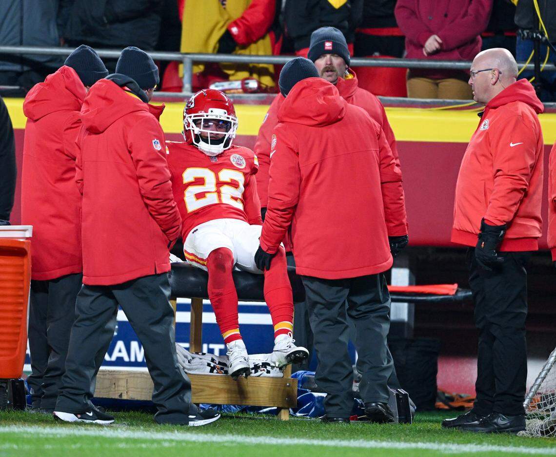 Kansas City Chiefs cornerback Trent McDuffie (22) talks to trainers after suffering an injury in the first quarter of the game against the Houston Texans at GEHA Field at Arrowhead Stadium on Sunday, Dec. 7, 2025.