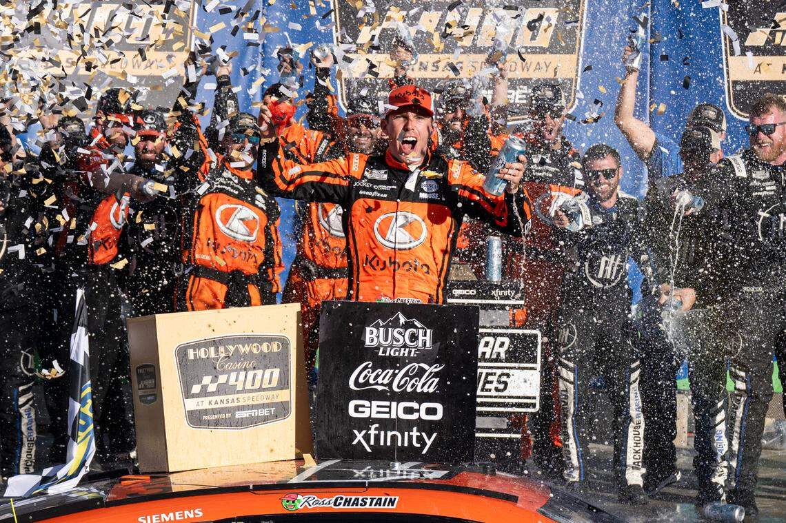 NASCAR Cup Series driver Ross Chastain celebrates in Victory Lane with his team following his Hollywood Casino 400 victory on Sunday at Kansas Speedway.