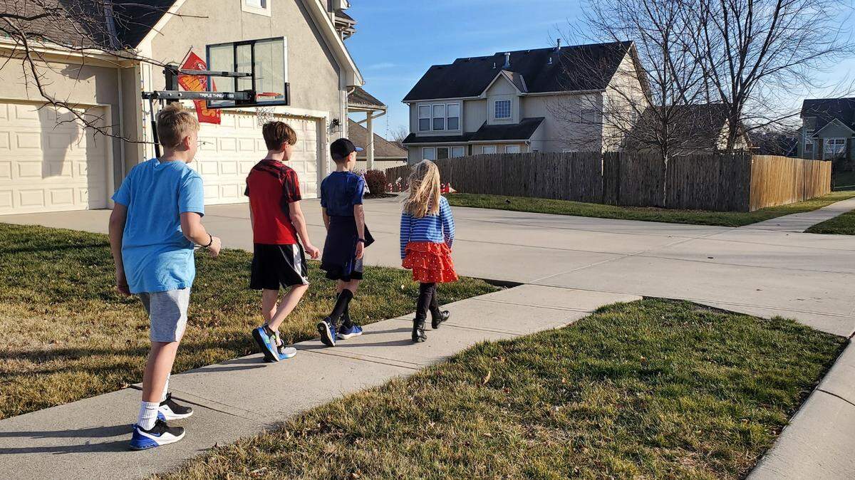 Charlie Mathis, Jackson Wichman, Carter & Nora Bearce take a walk on an unseasonable warm winter day.