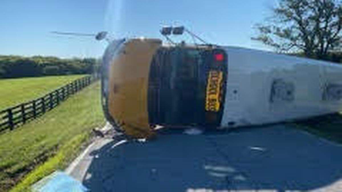 A Smithville school system bus lays on its side after overturning on Mt. Olivet Road, near Jami Drive and Northeast 120th Street, on Monday, September 12. Thirty students were on the bus when it crashed, and two students and the bus driver suffered minor injuries.