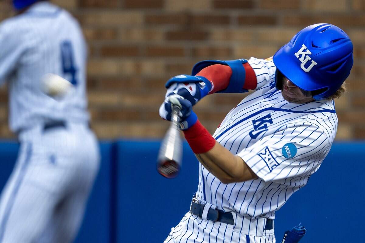 Kansas utility player Jordan Bach (31) hits a solo home run in the eighth inning of an NCAA Tournament baseball game against Oklahoma at Hoglund Ballpark on Saturday, June 6, 2026, in Lawrence.