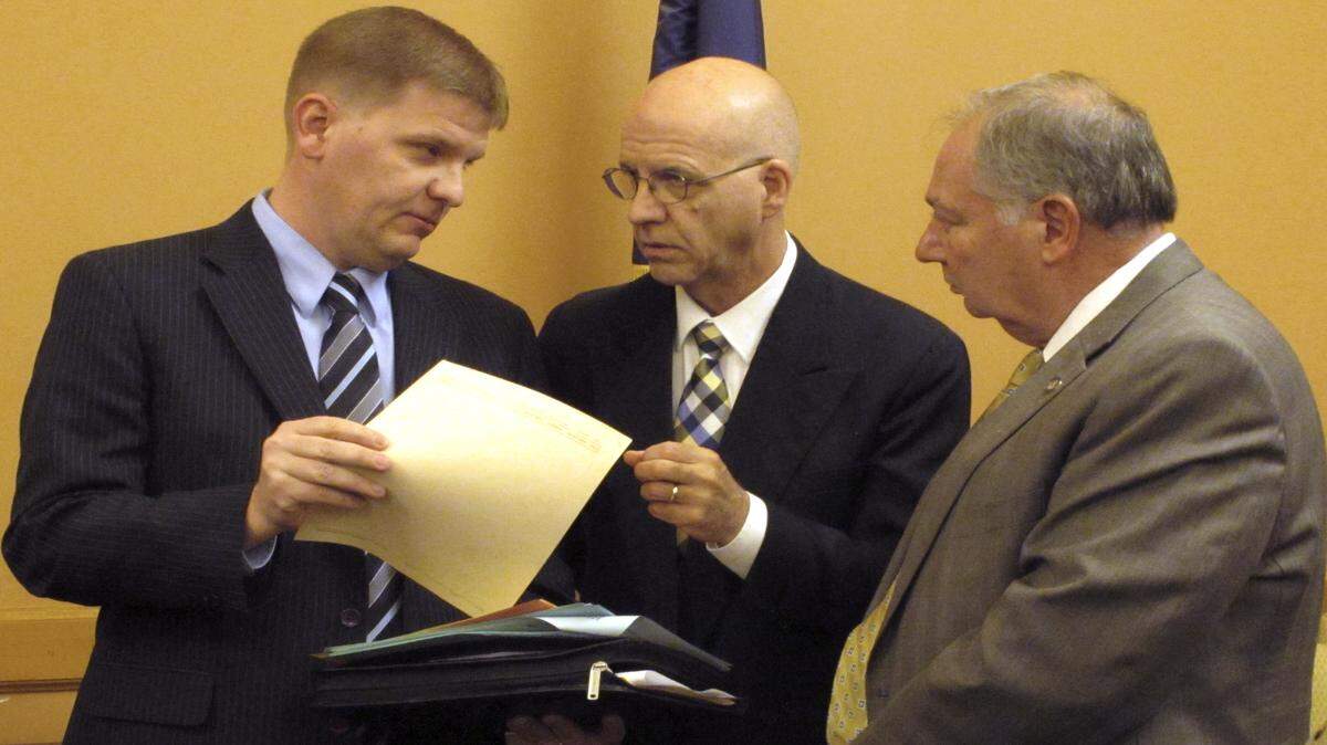 Shawn Sullivan, left, Kansas Gov. Sam Brownback's budget director, confers with J.G. Scott, center, the chief fiscal analyst for the Kansas Legislature's research staff, and Senate Majority Leader Jim Denning, R-Overland Park, right, following a meeting of the Senate Ways and Means Committee, Monday, March 20, 2017, at the Statehouse in Topeka, Kan. The committee is proposing a two percent pay raise for most state workers. 