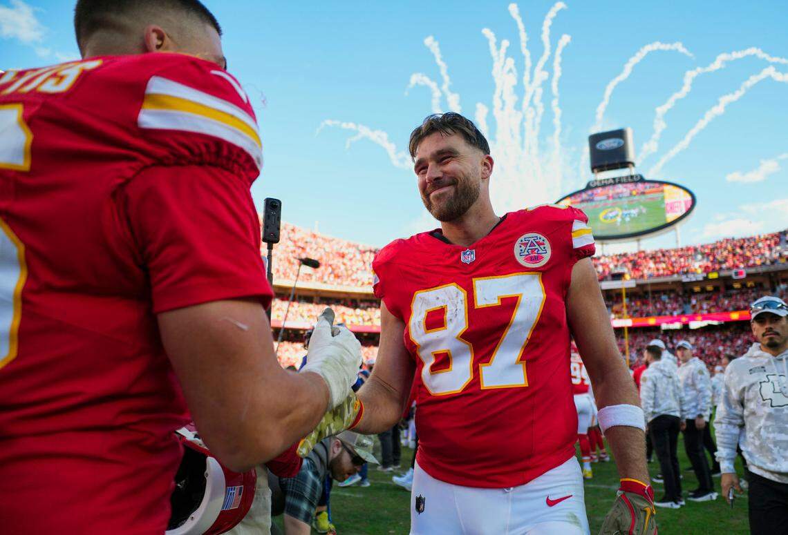 Kansas City Chiefs tight end Travis Kelce (87) celebrates with defensive end George Karlaftis (56) after defeating the Denver Broncos at GEHA Field at Arrowhead Stadium.
