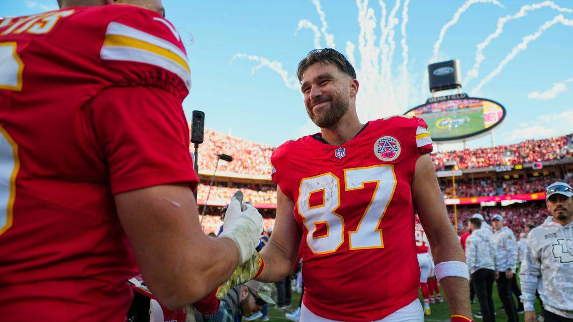 Kansas City Chiefs tight end Travis Kelce (87) celebrates with defensive end George Karlaftis (56) after defeating the Denver Broncos at GEHA Field at Arrowhead Stadium.