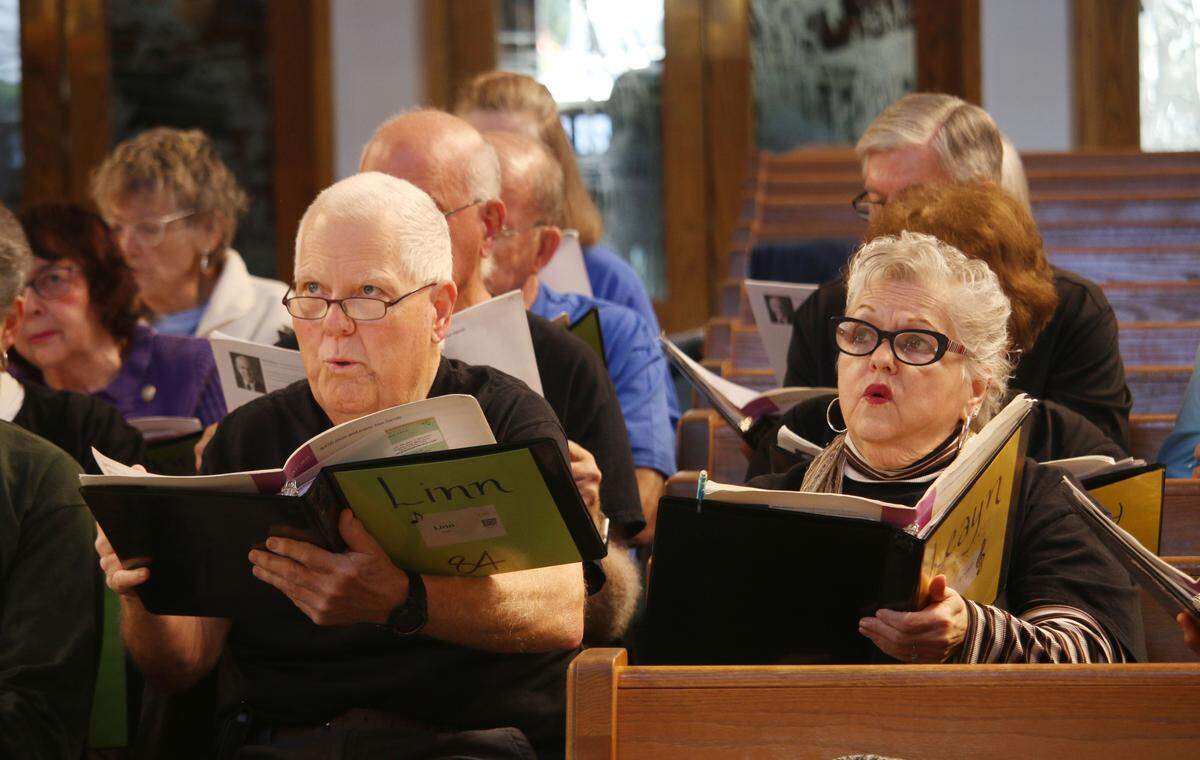 Linn Field and Leayn Losh keep their eye on the conductor during at EncoreKC! rehearsal at Grace Covenant Presbyterian Church in Overland Park.
