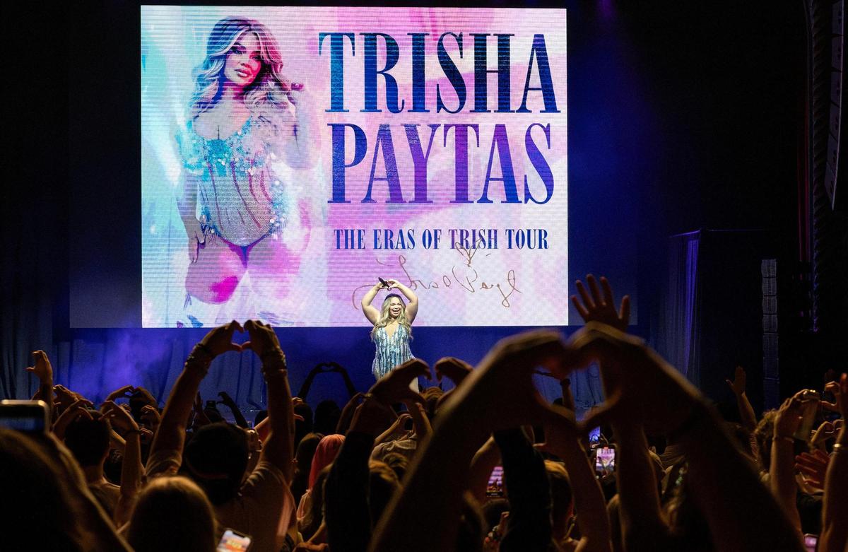 Trisha Paytas exchanges hand hearts with her fans on the stage of The Eras of Trish Tour at Uptown Theater on Thursday, May 29, 2025, in Kansas City.