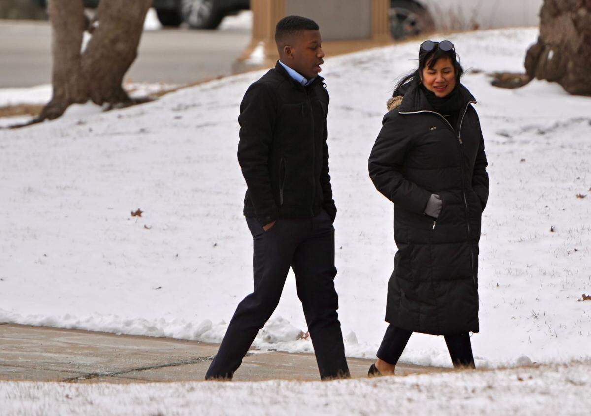 Ralph Yarl walks into the Clay County Courthouse in Liberty with an unidentified woman on Friday, Feb. 14, 2025, for a change of plea hearing for Andrew Lester, the Kansas City man accused in the high-profile shooting of Yarl in 2023. Lester pleaded guilty to a second-degree assault charge.