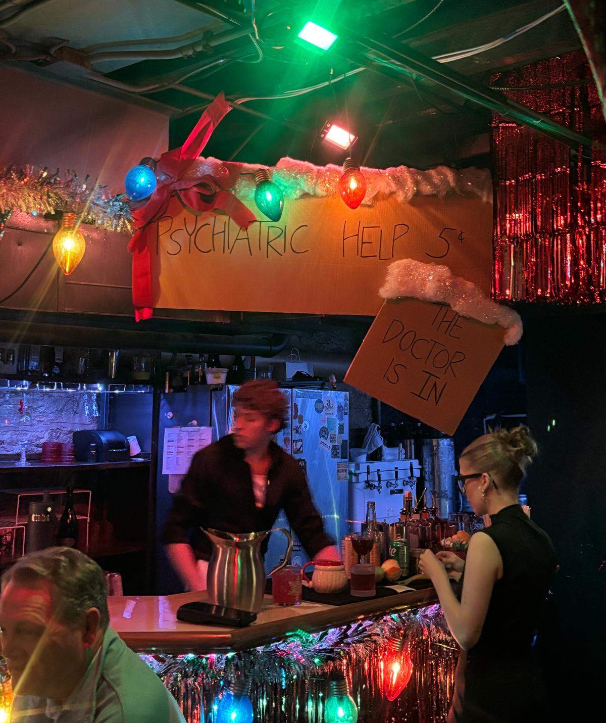 The basement bar inside of Tom’s Town is decorated for Christmas with a Peanut’s-themed sign. Dec. 4, 2025.