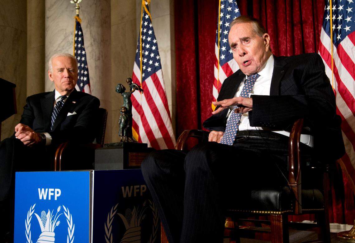 Former Senate Majority Leader Bob Dole, right, speaks after being presented with the McGovern-Dole Leadership Award by Vice President Joe Biden, left, to honor his leadership in the fight against hunger, during the 12th Annual George McGovern Leadership Award Ceremony hosted by World Food Program USA, on Capitol Hill in Washington, Wednesday, Dec. 11, 2013. This year, the award was renamed McGovern-Dole Leadership Award, to honor their pioneering efforts to feed the hungry both in the United States and around the world. (AP Photo/Manuel Balce Ceneta)