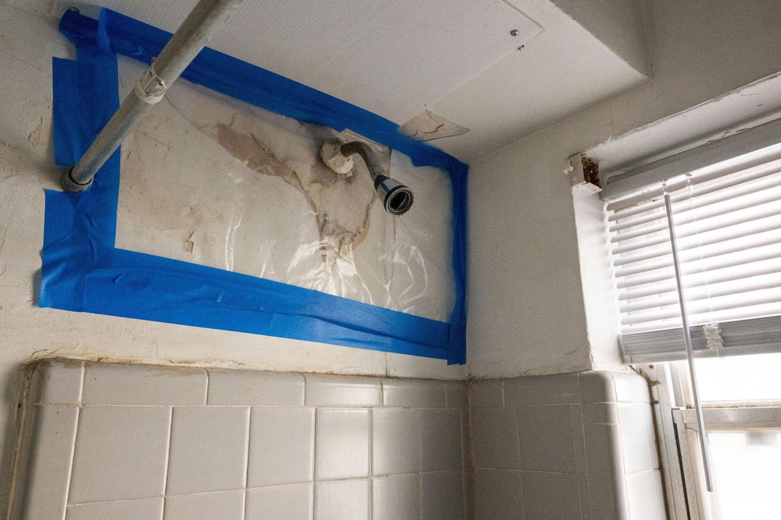 A damaged wall in a shower in Derek Harris’ apartment in Quality Hill Towers in Kansas City on September 5, 2024.