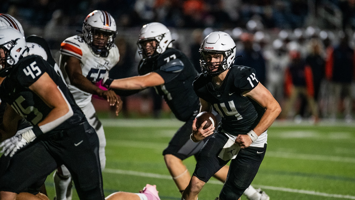 Mill Valley quarterback Connor Bohon, right, scrambles for yardage during the Jaguars’ 48-17 win over Olathe East in a Friday night high school football game.