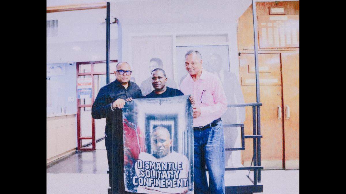 Anthony Gay, center, advocates for reform to solitary confinement practices. He’s received support from Jesse Jackson, right.
