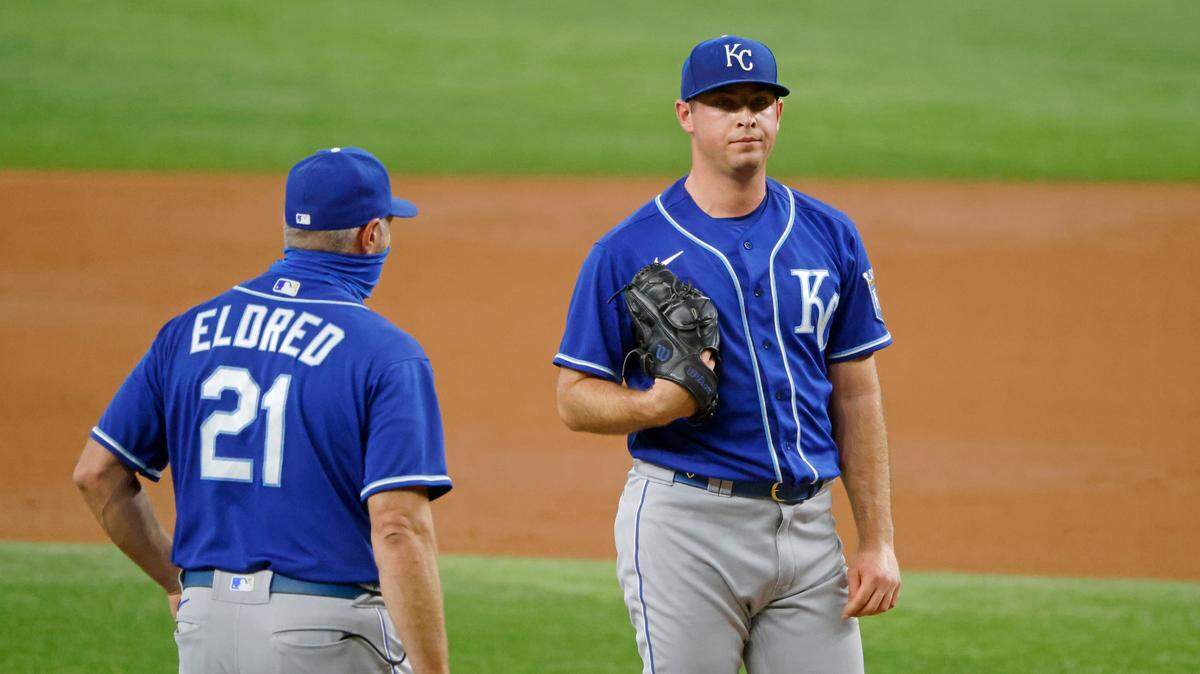 Kansas City Royals pitching coach Cal Eldred (left) checks on pitcher Kris Bubic after Bubic gave up two runs to the Texas Rangers during the second inning on Saturday, June 26, 2021, in Arlington, Texas.