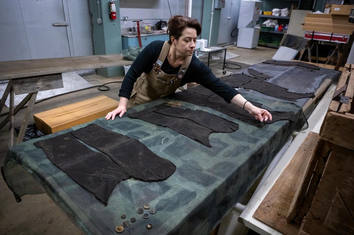 Textiles conservator Holly Messinger examines pieces of a man’s frock coat she was preserving at the Arabia Steamboat Museum in Kansas City on Thursday, April 18, 2025. The coat, recovered from the Arabia steamboat which sank in 1856, has been stored in a freezer awaiting preservation since the recovery of the ship and its cargo in 1988.