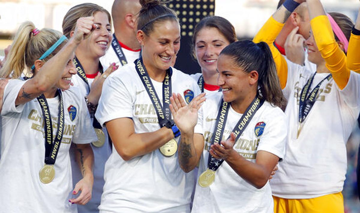North Carolina Courage’s Debinha, front right, is congratulated by teammates after being named the MVP of an NWSL championship soccer game against the Chicago Red Stars in Cary, N.C., Sunday, Oct. 27, 2019.