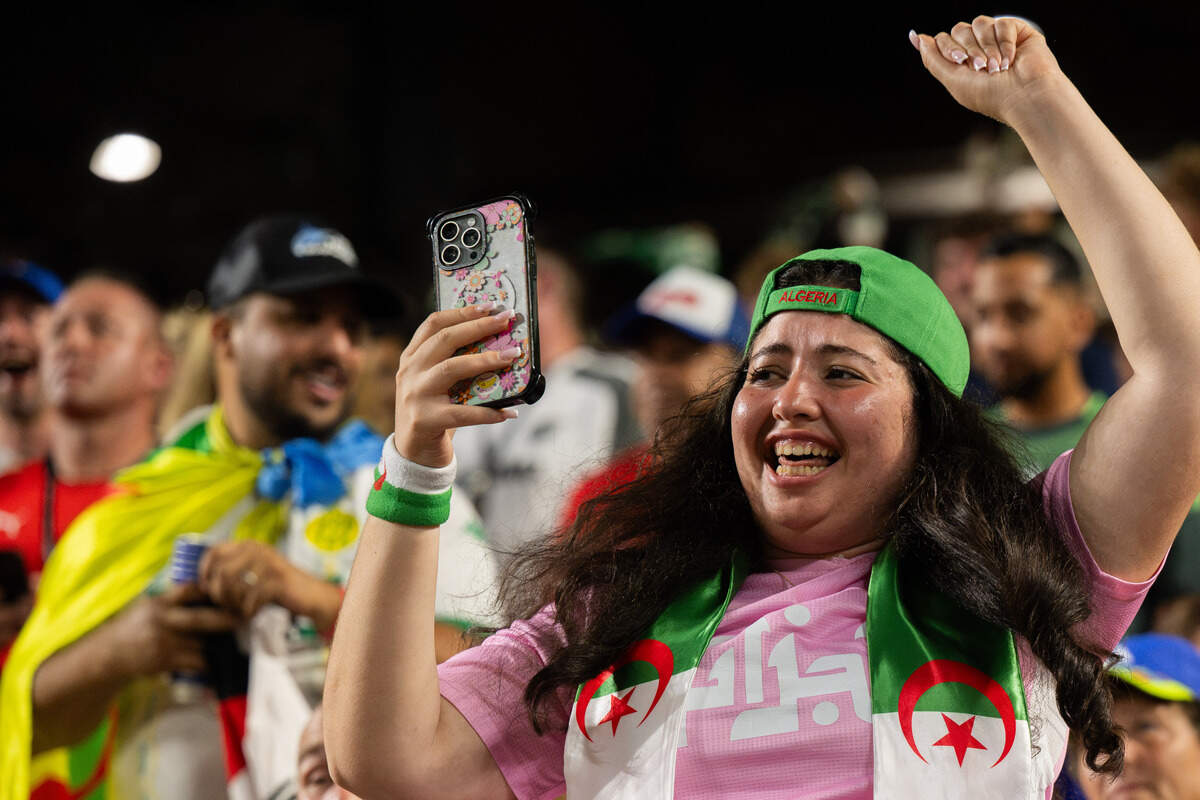 An Algerian fan celebrates at World Cup match at Kansas City (Arrowhead) Stadium.