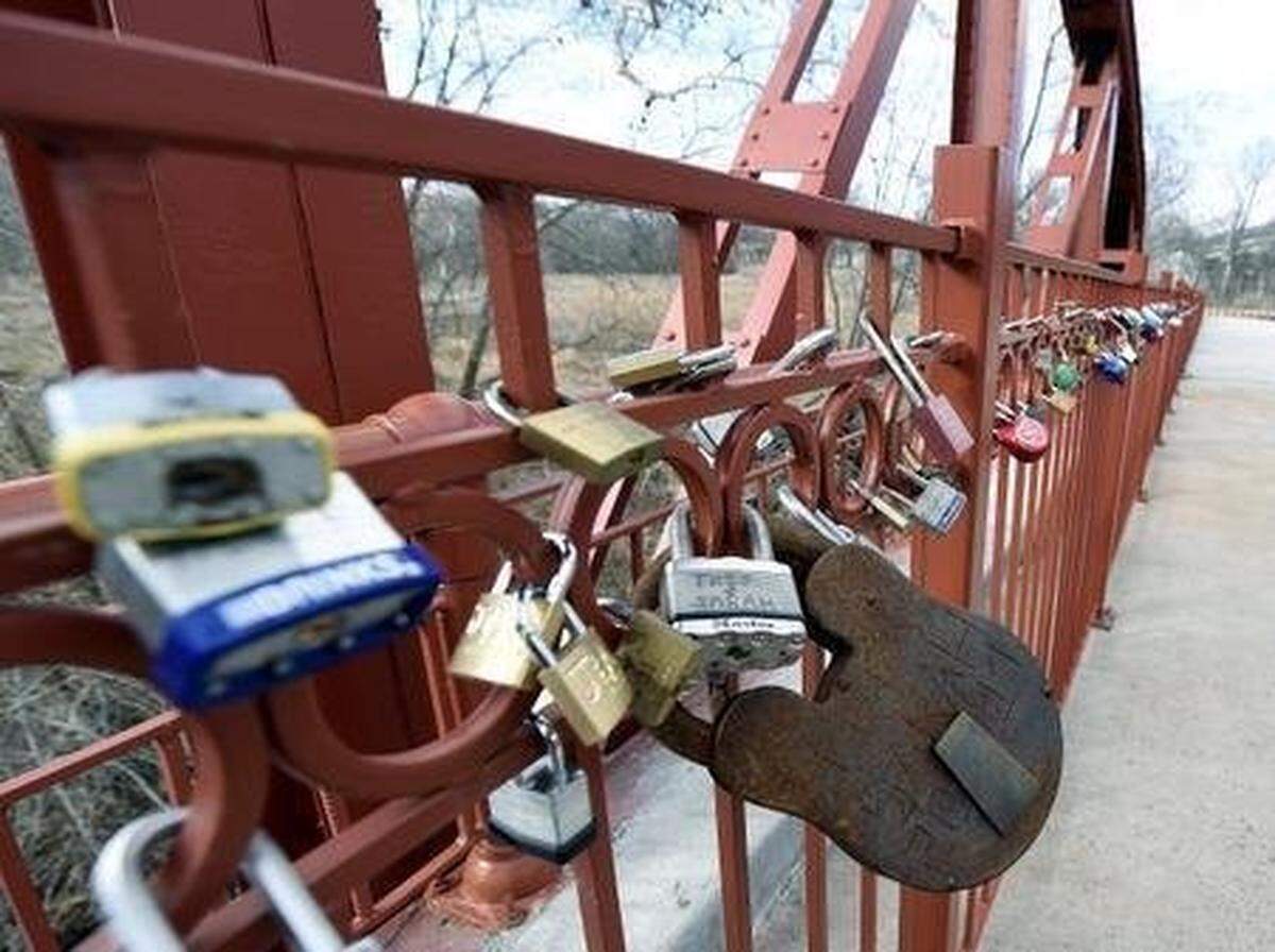 The Old Red Bridge in Minor Park is a popular spot for couples to display their love by attaching locks to the bridge.