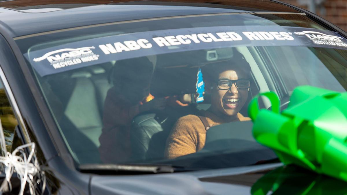 Tyisha Russell, the mother of four children, laughs while sitting in a car donated to her family from the Urban League of Greater Kansas City on Wednesday, Jan. 11, 2023, in Kansas City.