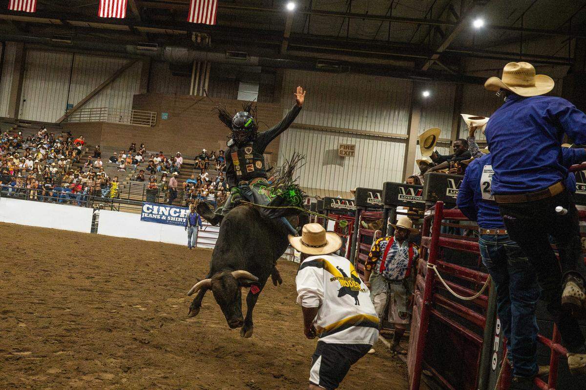 Au’Vion Horton rides a bucking bull on the back of “Mr. Nasty,” at the Black Rodeo USA show at Hale Arena in Kansas City on Saturday. Horton is one of the premier Black bull riders in the country.