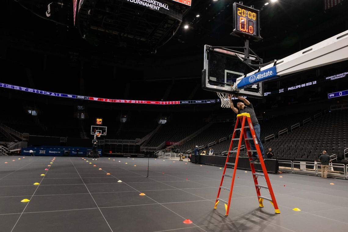 Employees of ASB GlassFloor test and finish installing the companies state-of-the-art glass LED basketball court, on Monday, March 2, 2026, at T-Mobile Center. The court, being used for the first time for a college basketball game, is controlled through a tablet which is capable of changing the look of the court at the press of a button.
