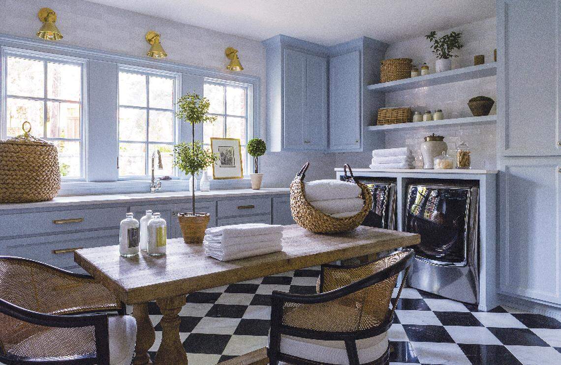 Pale blue cabinets and black and white checkerboard floors give this laundry room in a Mission Hills home personality.