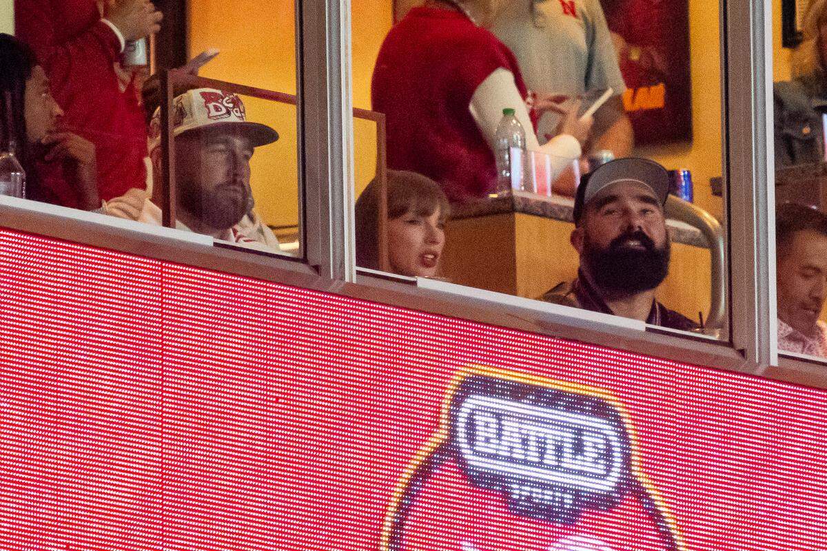 Travis Kelce, Taylor Swift and Jason Kelce watch during the second quarter between the Cincinnati Bearcats and the Nebraska Cornhuskers at GEHA Field at Arrowhead Stadium. 