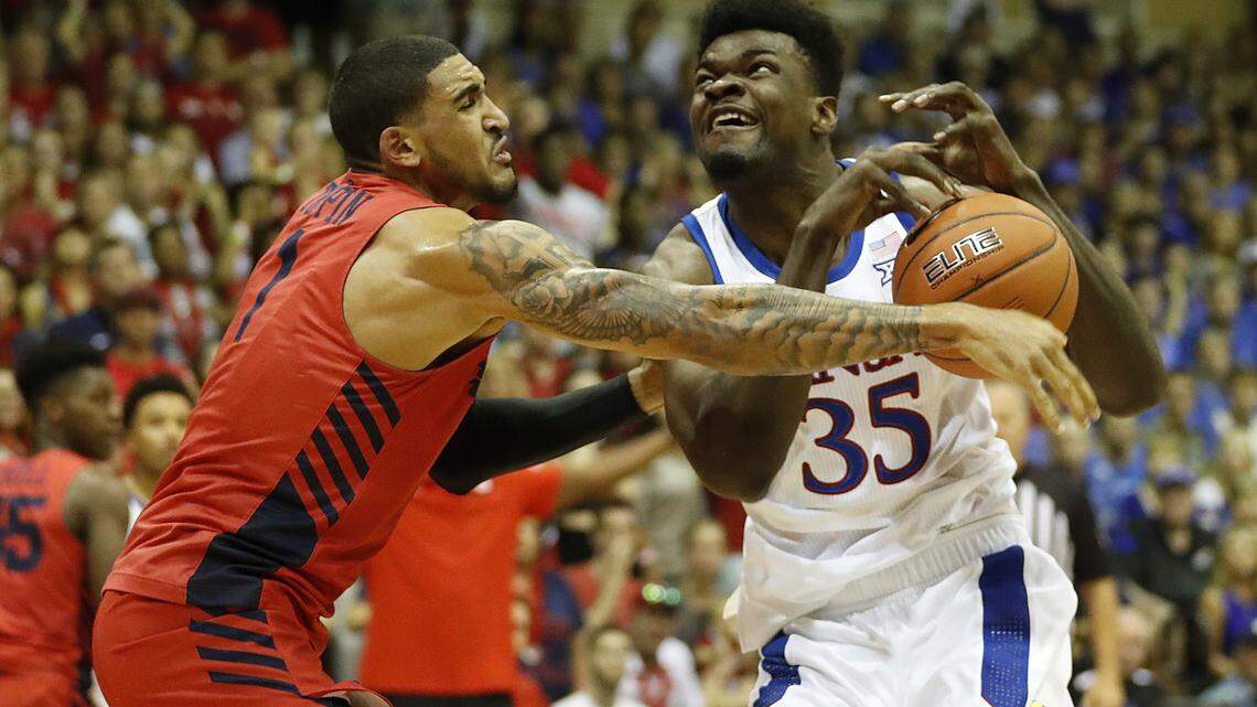 Dayton forward Obi Toppin (1) knocks the ball away from Kansas center Udoka Azubuike (35) during the first half of an NCAA college basketball game Wednesday, Nov. 27, 2019, in Lahaina, Hawaii. (AP Photo/Marco Garcia)
