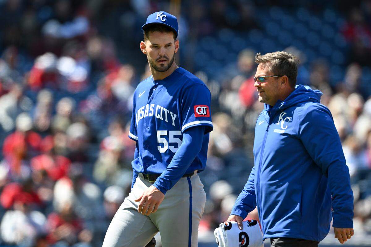 Royals pitcher Cole Ragans, left, walks off the field with a trainer after being hurt during an April 8, 2026 game against the Guardians at Progressive Field in Cleveland on April 8, 2026.