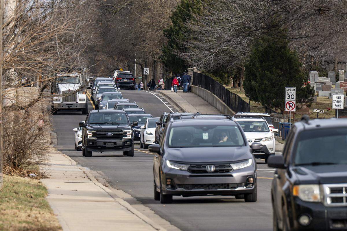 People walk along West 83rd Street near Corinth Elementary School on Thursday, Jan. 15, 2026, in Leawood.