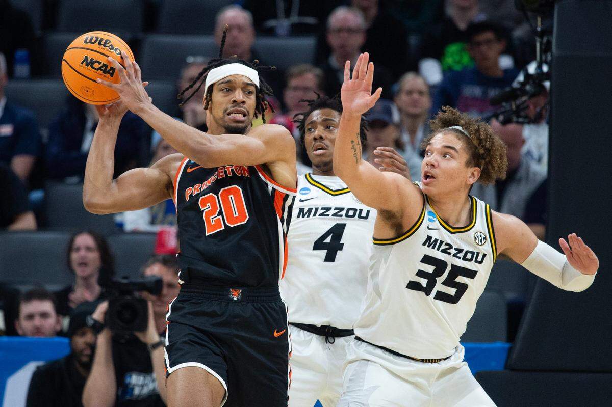 Princeton Tigers forward Tosan Evbuomwan (20) passes around the Missouri Tigers’ DeAndre Gholston (4) and Noah Carter (35) during their second-round game in the NCAA Tournament at Golden 1 Center in Sacramento, Saturday, March 18, 2023.