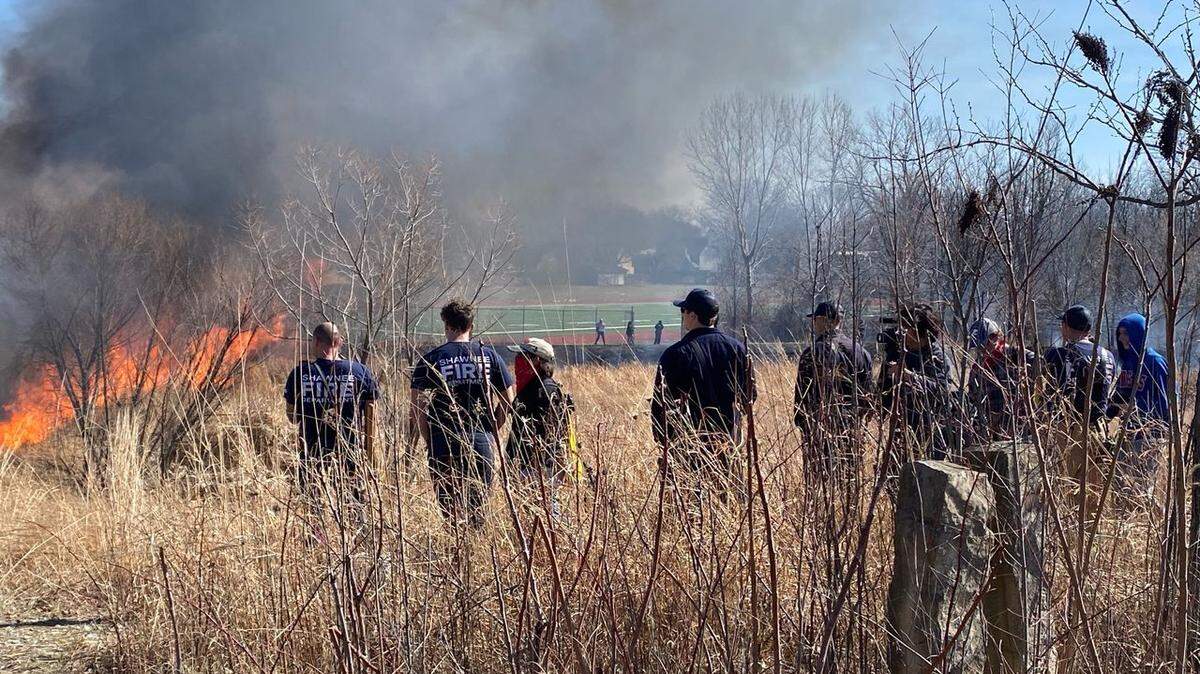Every year, Shawnee firefighters team up with Shawnee Mission Northwest High students to burn off a field on school property. It gives the students a hands-on firefighting lesson.