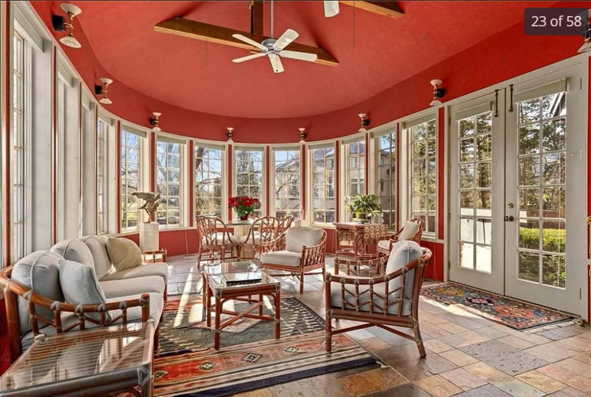 The window-lined sunroom of the home for sale at 11409 Meadow Lane in Leawood is seen in this listing photo.