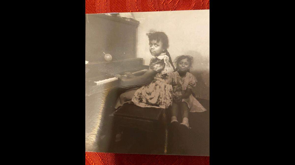 Sonja Holbert sits at the piano as a child. Her father instilled in her a passion for classical music.