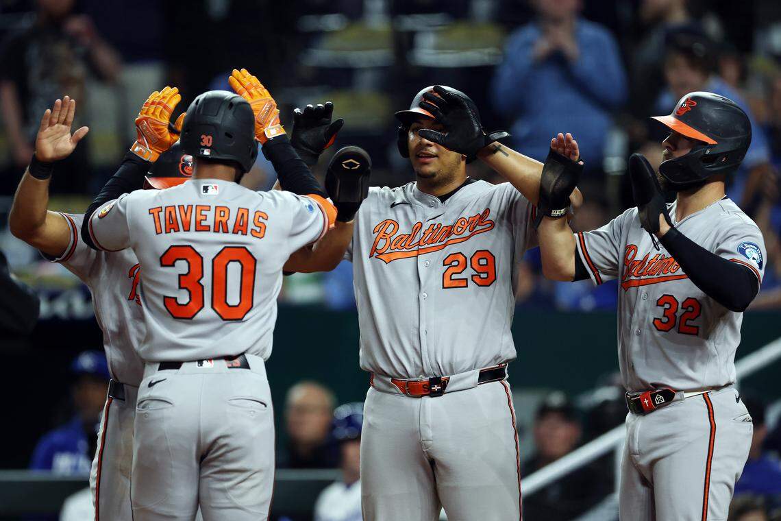 Leody Taveras #30 of the Baltimore Orioles is congratulated by teammates after hitting a grand slam home run during the 12th inning of the game against the Kansas City Royals at Kauffman Stadium.