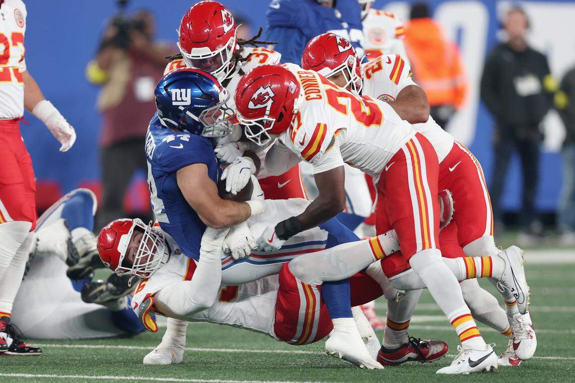 Kansas City Chiefs tacklers George Karlaftis (No. 56), Chamarri Conner (27) and Nick Bolton (32) converge on New York Giants running back Cam Skattebo (No. 44) during an NFL Week 3 game at MetLife Stadium in East Rutherford, New Jersey, on Sunday, Sept. 21, 2025.