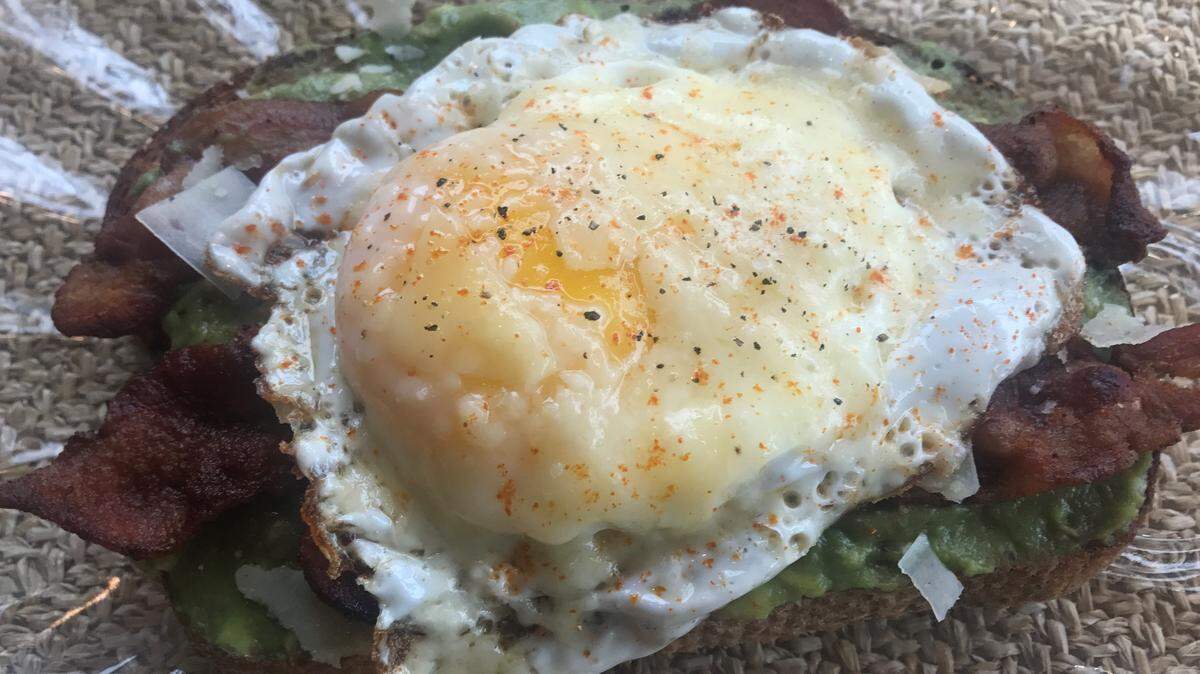 Wheat Neighborhood Table’s savory toast the Carol has avocado, Parmesan, crisp bacon, fried or scrambled egg and seasoned sprinkles.
