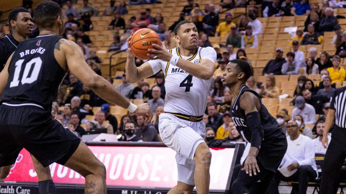 Missouri’s Javon Pickett, center, drives between Mississippi State’s Garrison Brooks, left, and Iverson Molinar, right, during the second half of an NCAA college basketball game Sunday, Feb. 20, 2022, in Columbia, Mo. Mississippi State won 58-56. (AP Photo/L.G. Patterson)