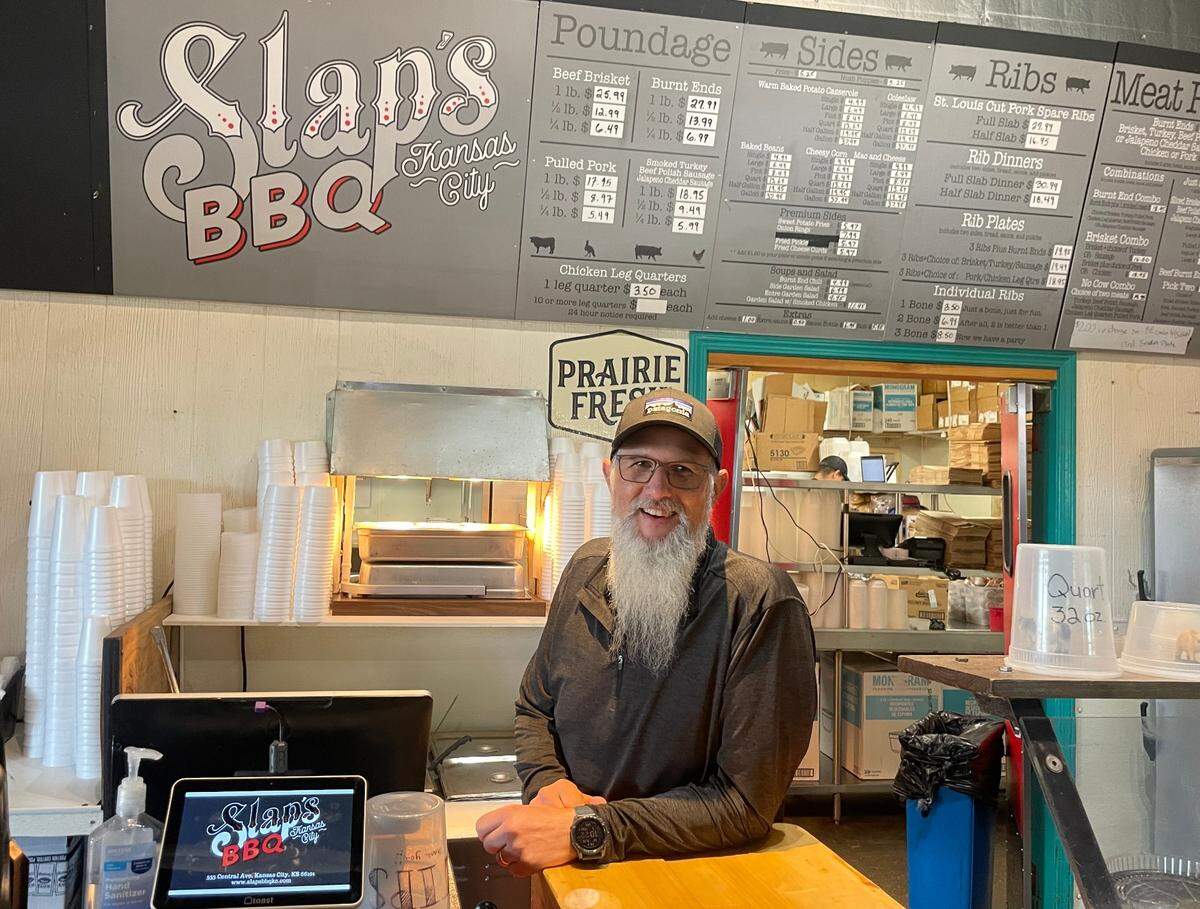 Mike Pearce stands behind the counter of Slap’s BBQ, the award-winning Kansas City, Kansas, restaurant he and his brother, Joe, opened in 2014.