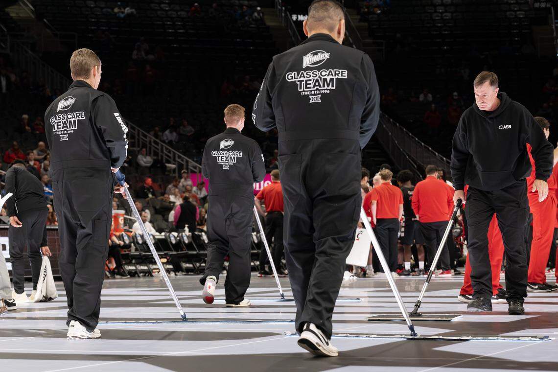 Members of the Windex glass care team clean the court during the second half of a Big 12 Men's Basketball Tournament game between the Cincinnati Bearcats and the UCF Knights at T-Mobile Center on Wednesday, March 11, 2026, in Kansas City.