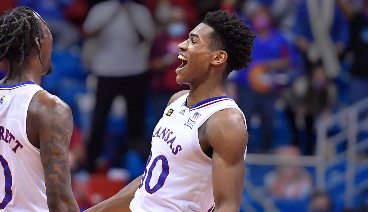 KU teammates Marcus Garrett, left, and Ochai Agbaji celebrate Garrett’s steal and dunk during the second half of Thursday night’s Big 12 Conference game at Allen Fieldhouse. KU beat TCU, 59-51.