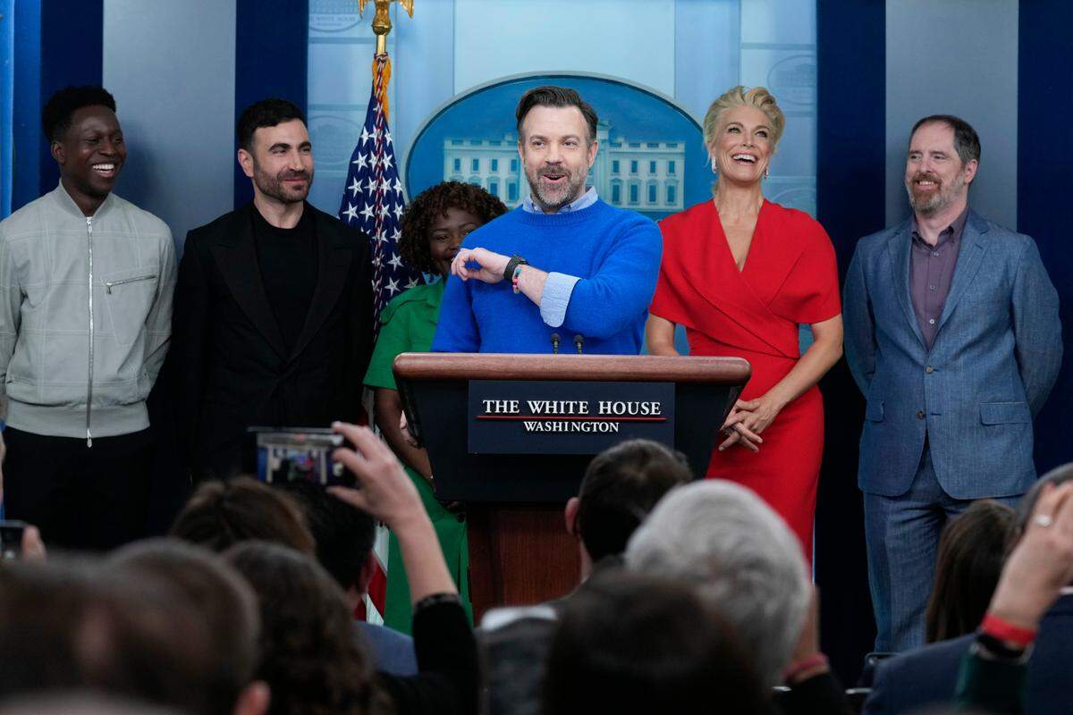 Jason Sudeikis, center, aka Ted Lasso, spoke at the White House daily briefing on Monday in Washington. He was flanked by, from left, cast members Toheeb Jimoh, Brett Goldstein, White House press secretary Karine Jean-Pierre, Hannah Waddingham and Brendan Hunt.