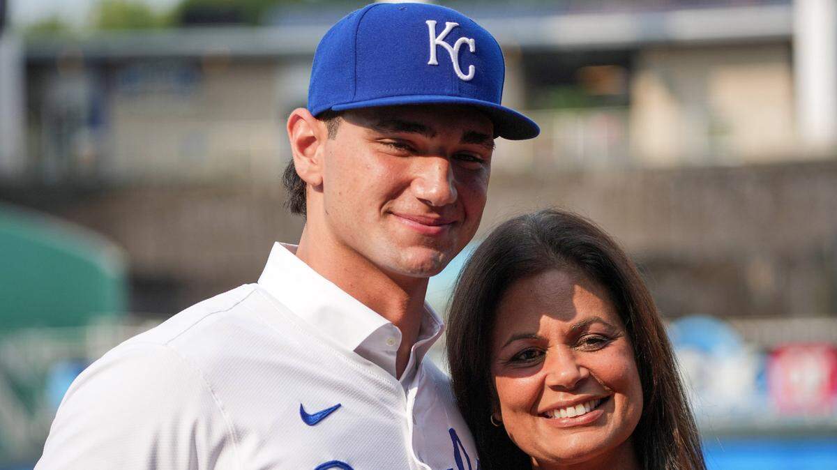 Kansas City Royals first round draft pick Jac Caglianone poses with his mother Johanne Caglianone for photos on the field prior to a game against the Arizona Diamondbacks at Kauffman Stadium on Jul 24, 2024 in Kansas City, Missouri, USA.