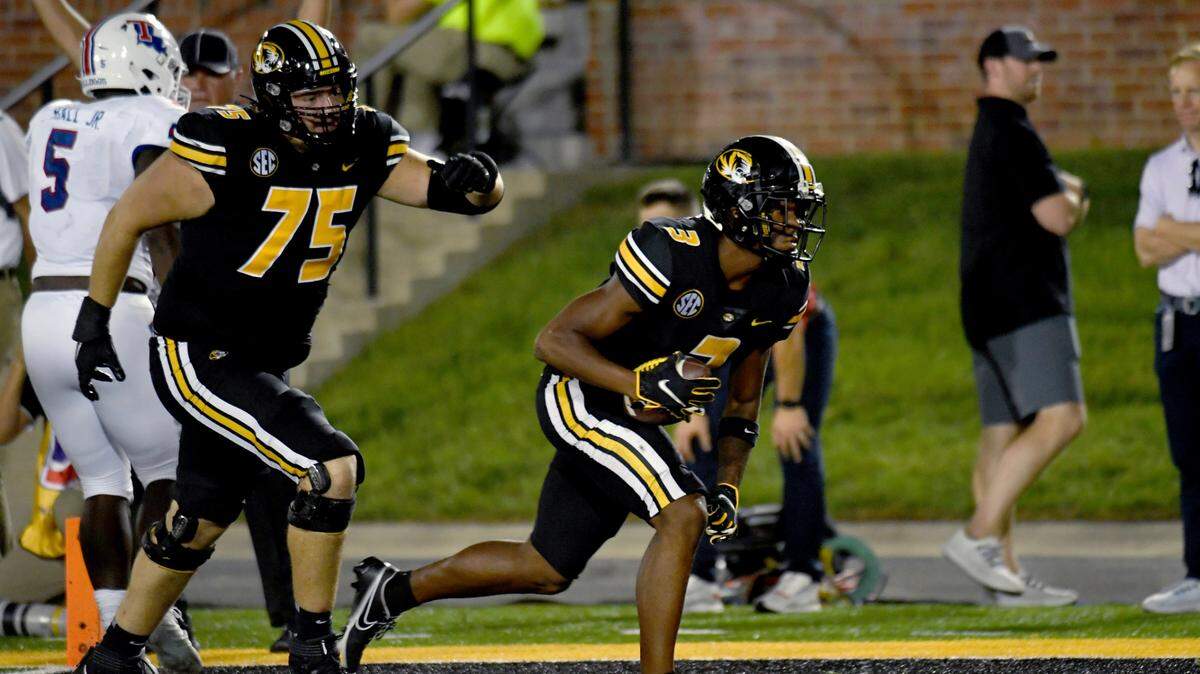 Missouri wide receiver Luther Burden III scores as teammate Mitchell Walters (75) watches during the first half of an NCAA college football game against Louisiana Tech Thursday, Sept. 1, in Columbia, Mo. (AP Photo/L.G. Patterson)