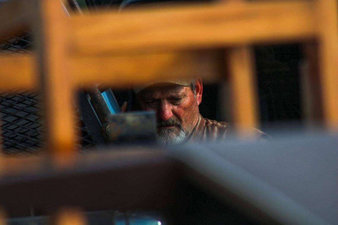 Douglas Clement, 58, talks on the phone while he searches through a destroyed storage building for his boss’ daughter at Hillsdale Boat & Mini Storage on April 14, 2026. A tornado caused widespread damage in the area, completely destroying most of the storage unit buildings on the property.