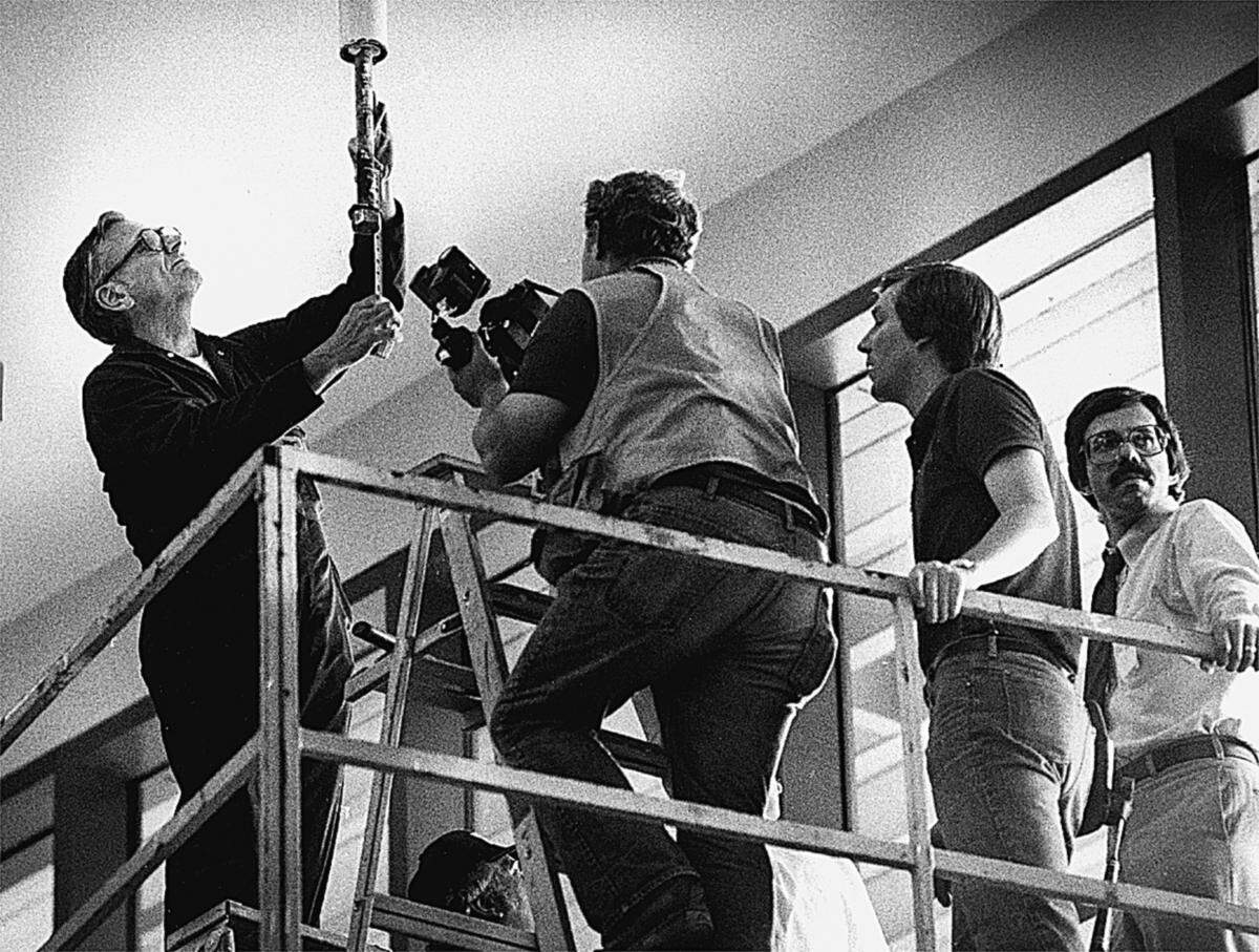 Investigators examine one of the rods at the point from which the skywalks were hung.