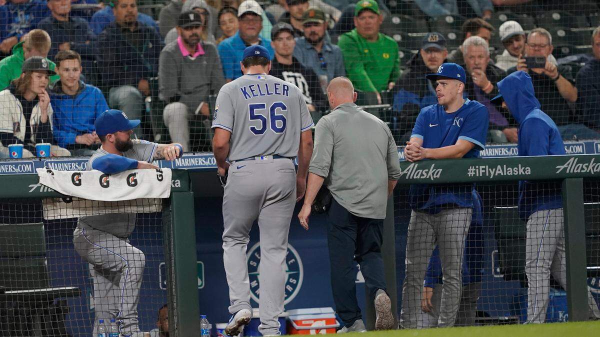 Kansas City Royals starting pitcher Brad Keller (56) leaves the baseball game against the Seattle Mariners with a trainer during fifth inning Thursday, Aug. 26, 2021, in Seattle. (AP Photo/Ted S. Warren)