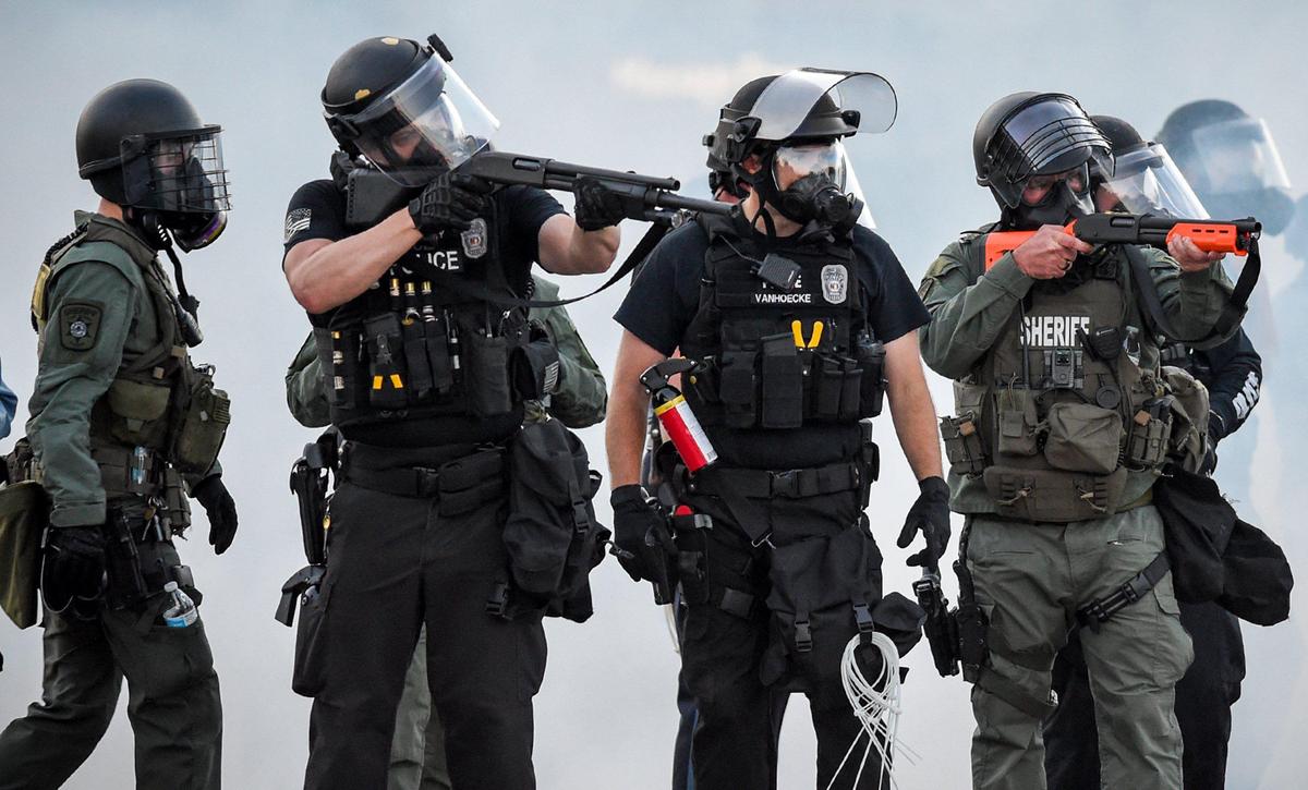 During a third night of protests, members of the Kansas City police and Jackson County Sheriff launched tear gas and aimed weapons with less-lethal rounds at protesters Sunday near the Country Club Plaza in Kansas City.
