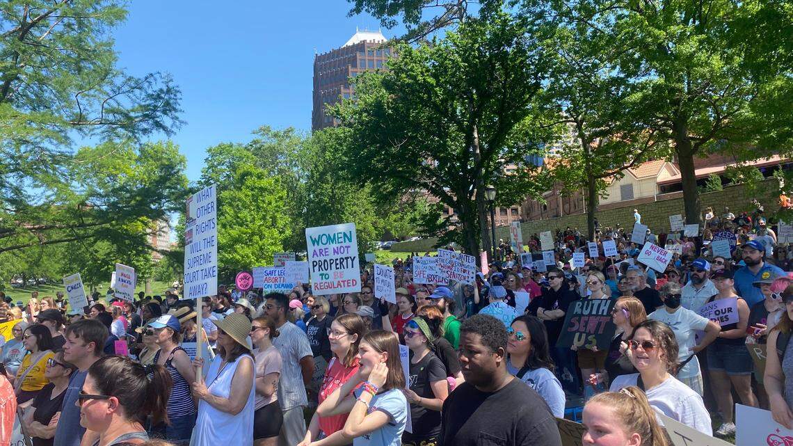 Several people gather Saturday afternoon at Mill Creek Park in Kansas City at a “Bans Off Our Body” rally. Around 300 protesters listened to several speakers and marched around the Plaza.