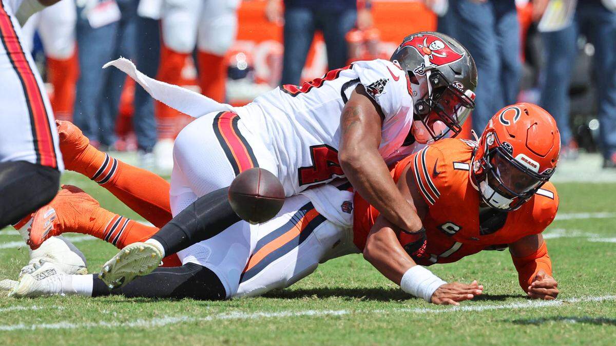 Tampa Bay Buccaneers linebacker Cam Gill (49) sacks Chicago Bears quarterback Justin Fields (1) and forces him to fumble the ball during the second quarter at Raymond James Stadium.