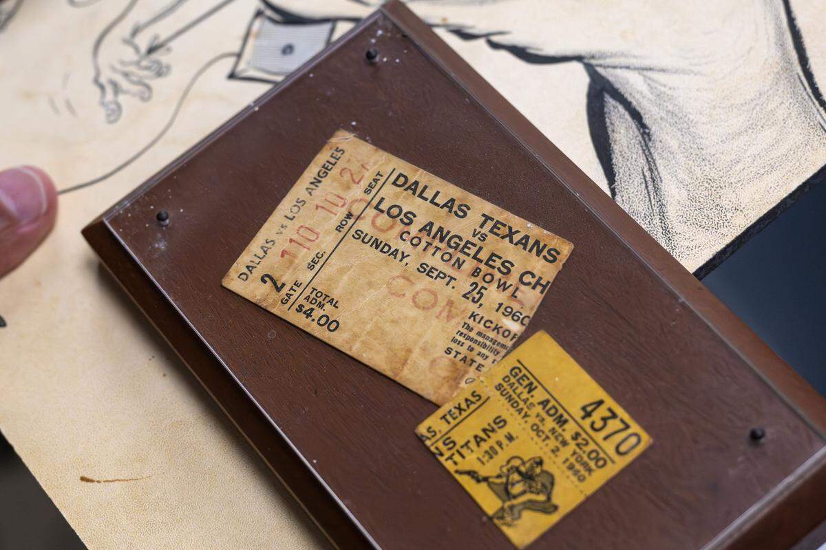 A game ticket, dated Sept. 25, 1960, for a matchup between the Dallas Texans and Los Angeles Chargers, is stored in a protective case inside the Library Room at the Kansas City Chiefs' underground storage facility in Kansas City.